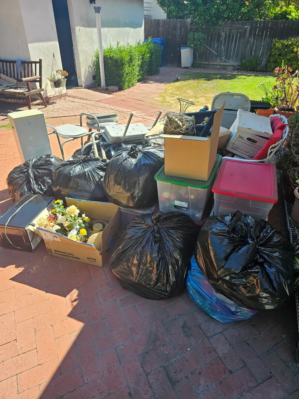 Bagged household items, furniture and boxes on a patio